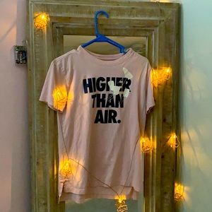 This is a small light pink Nike t-shirt